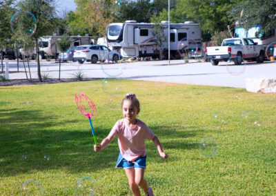 A girl plays while camping near austin in texas hill country